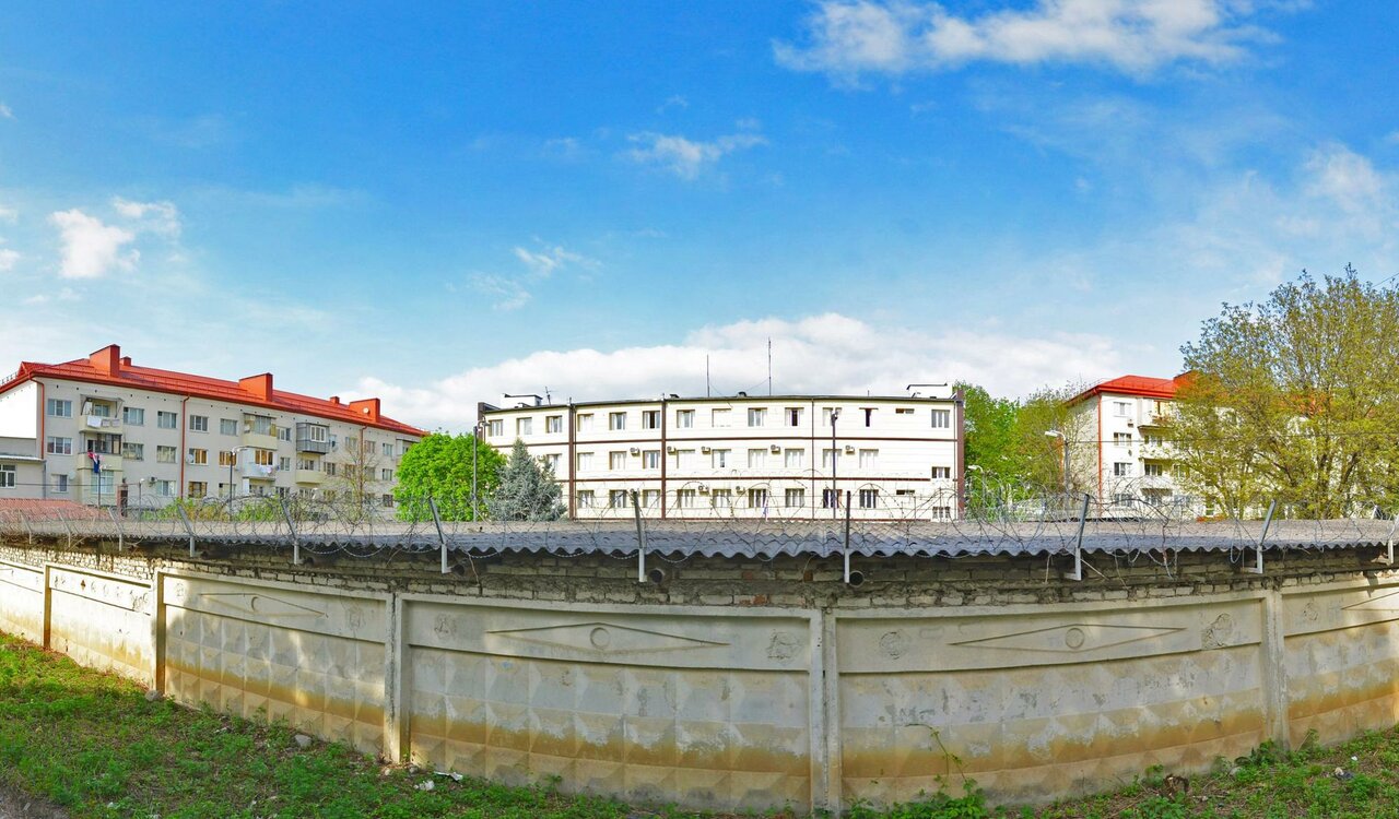 A panorama view of three buildings. The building in the centre is the Department of the Ministry of Internal Affairs of Russia for the city of Nalchik, where the police officer who extorted the money worked. Nalchik, Baysultanova st., 11А. March 2025. Source: yandex.com
